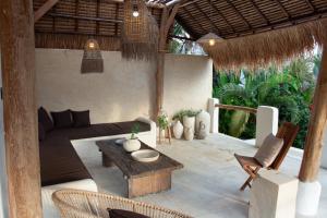 a living room with a couch and a table and chairs at Villa Bella - Stylish 3-Bedroom Oasis with Mediterranean Charm in Canggu