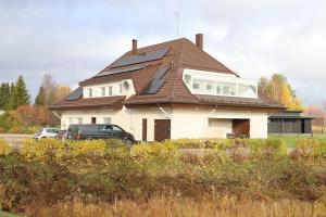 a house with a roof with a car parked in front at Luxury Apartment in the Heart of Pello in Pello