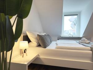 Ένα ή περισσότερα κρεβάτια σε δωμάτιο στο MyStay I Central Lofts I Superior Design Apartments Heidelberg