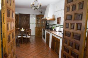 a kitchen with a table and a dining room at casa rural la Venta de Agar Orgaz, Toledo 30 min Puy du fou in Orgaz +33 photos