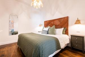 a bedroom with a large bed and a mirror at Hollyhock Suite 507 in Louisville