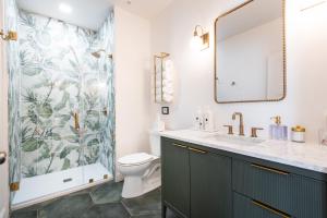 a bathroom with a shower and a sink and a toilet at Hollyhock Suite 507 in Louisville