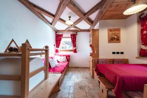 a bedroom with a bunk bed and a couch at Chalet Pian in Campitello di Fassa