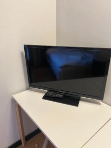a flat screen tv sitting on top of a white table at Egtved Hotel in Egtved