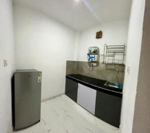 a small kitchen with a counter and a sink at Air Rooms in Lohārakot