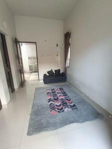 a living room with a rug on the floor at Rumah 2 kamar dekat Jl Raya Propinsi in Kebumen