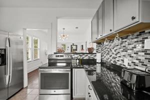 una cucina con fornelli e frigorifero di Hardy House Vintage Bungalow, Huge Yard! a Houston