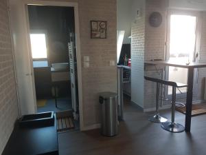 a small kitchen with a counter and a table at Studio accès direct Promenade Marcel Proust in Cabourg