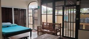 a bedroom with a bed and a chair and windows at JMC7 Furnished Villa Near Panglao Airport in Panglao