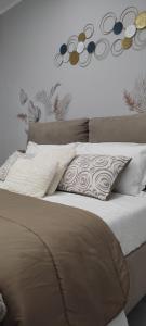 a bed with pillows on it in a bedroom at Casa vacanza Luna in Eboli