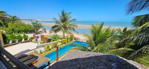 a view of the beach from the balcony of a resort at Upwind Villas Boutique - Praia de Maceió - Camocim - CE in Maceio