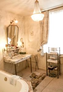 a bathroom with a tub and a sink and a mirror at " Chimay B & B " - ptits déj gourmands proposés in Chimay