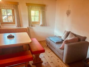 a living room with a couch and a table at Naturblick in Donnersbach