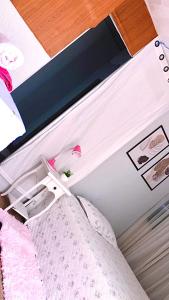 a bedroom with a bed with a white bed frame at Quartos Privados em casa Mobiliada in Londrina