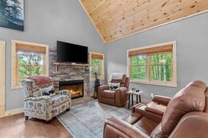 a living room with couches and a fireplace at Bear Necessities in Beech Mountain