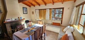 a living room with a table and a fireplace at Casa Pier Giorgio Bella Vista in El Chalten +16 photos