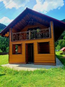 a small house with a balcony on top of it at Rusnak Family in Synevyrsʼka Polyana +11 photos