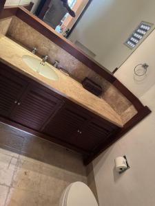 a bathroom with a sink and a toilet at Exclusive Luxury Waterfront Villa in Marina Real in Zihuatanejo +10 photos