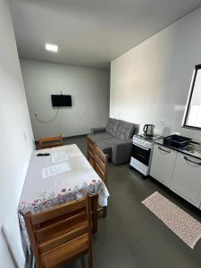 a room with a kitchen and a table and a couch at Casa em Sinop in Sinop