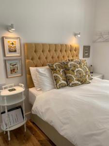 a bedroom with a large bed with a large headboard at 7 Goathill Crescent in Stornoway