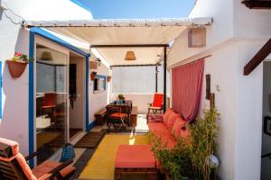a balcony with a living room and a dining room at Casa do Mar - Familiar T3 Duplex - Terraço - Central in Nazaré