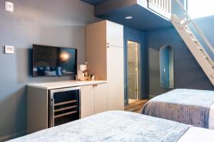 a room with two beds and a staircase in it at Hollyhock Suite 506 in Louisville