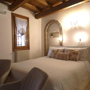 a bedroom with a large bed and a window at Nell'antico ghetto ebraico in Ferrara +33 photos