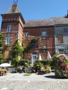 a large brick building with a patio in front of it at " Chimay B & B " - ptits déj gourmands proposés in Chimay