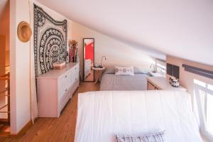 a bedroom with a bed and a dresser with a mirror at Casa do Mar - Familiar T3 Duplex - Terraço - Central in Nazaré
