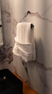 a stack of white towels hanging on a wall at Tribe Resorts in Juan Dolio