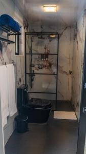 a bathroom with a black toilet in a room at Tribe Resorts in Juan Dolio +19 photos