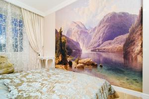 a bedroom with a painting on the wall at 33 Apartments in Minsk