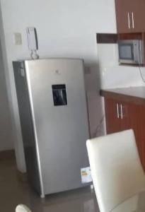 einen kleinen weißen Kühlschrank in der Küche in der Unterkunft Departamento 3 dormitorios Tacna en condomio privado in Tacna