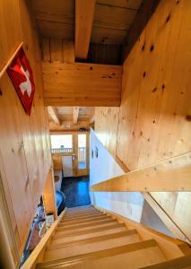 a room with wooden walls and stairs in a tree house at Chalet Talisman auf der Riederalp in Riederalp +35 photos