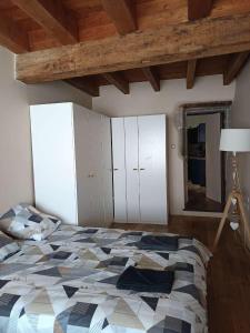 a bedroom with a large bed and a mirror at Appartement 6 personnes avec terrasse in Montbrison