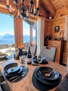 a dining room table with a view of the mountains at Chalet Talisman auf der Riederalp in Riederalp