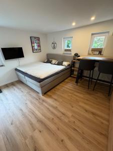 a bedroom with a bed and a table and chairs at LippeStay - Modernes Apartment für 2 in Werne an der Lippe
