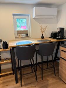 a kitchen with a table and four chairs at LippeStay - Modernes Apartment für 2 in Werne an der Lippe +5 photos