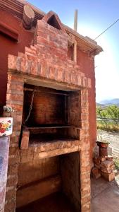 an old brick oven sitting outside of a house at Muxsa - Casa con vista a los Colorados in Purmamarca