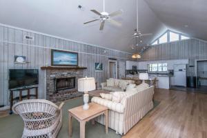 a living room with couches and a fireplace at Crowfield in Edisto Beach