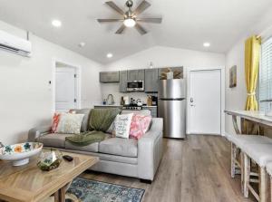 a living room with a couch and a kitchen at Book Me Baby! Wildflower Inn Siesta Key #3 Orchid in Siesta Key