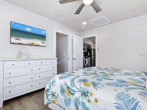 a bedroom with a bed and a tv on the wall at Book Me Baby! Wildflower Inn Siesta Key #3 Orchid in Siesta Key +42 photos
