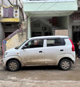 Una camioneta blanca estacionada frente a un edificio en Rudraksh Homestay, en Ujjain