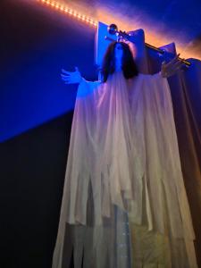 a woman in a white dress holding a cross at L Escale Spa Privatif in Tournai +63 photos