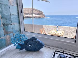a kitchen with a window with a view of the ocean at Ocean Attic Tufia in Telde