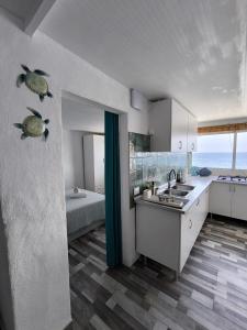 a kitchen with a sink and a bath tub at Ocean Attic Tufia in Telde