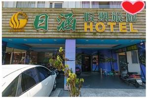 a hotel with a car parked in front of it at Ryhan Hotel in Zhongli