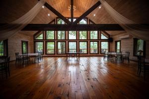 an empty room with tables and chairs and large windows at Willow Falls in Blue Ridge