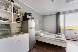 a small kitchen with a bed and a window at Exklusiv Küche Office Streaming Minibar 6311 in Bonn