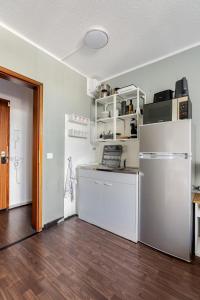 a kitchen with white appliances and a wooden floor at Exklusiv Küche Office Streaming Minibar in Bonn +7 photos